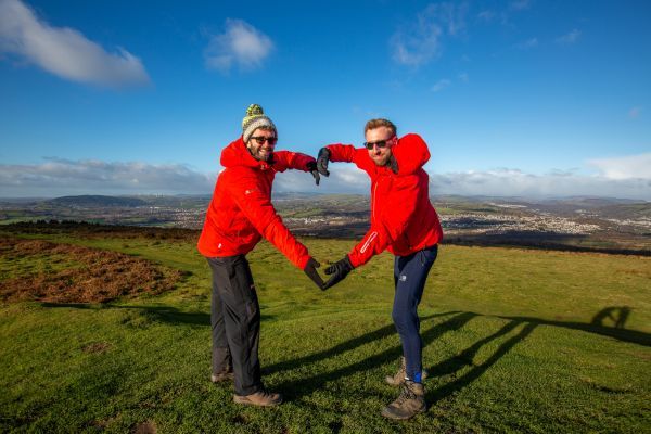 Two walkers creating a love heart with their arms